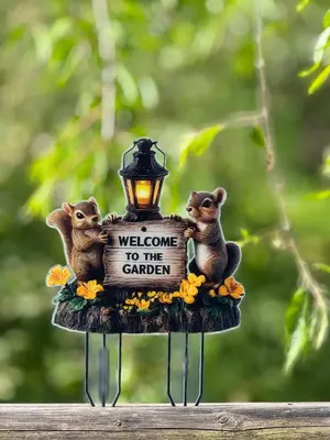 a figurine of three mice holding a welcome to the garden sign at Alice Chalet Bled - Adults only in Bled