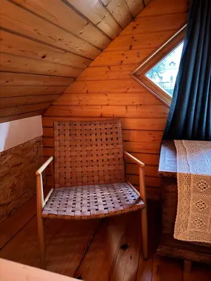 a chair in the attic of a log cabin at Alice Chalet Bled - Adults only in Bled