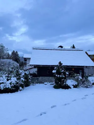 a house with a snow covered roof in a yard at Alice Chalet Bled - Adults only in Bled