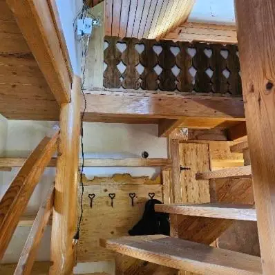 an attic room with wooden stairs in a house at Alice Chalet Bled - Adults only in Bled