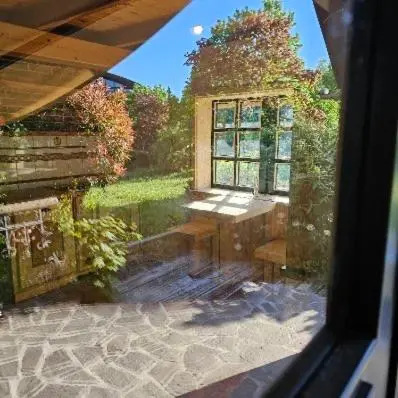a view of a garden from a window of a house at Alice Chalet Bled - Adults only in Bled