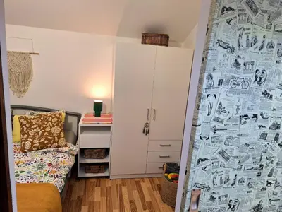 a bedroom with a bed and a wall covered in drawings at Boho House 5 camp Terme Catez with promotional tickets prices in Čatež ob Savi