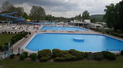 a large swimming pool with a slide in a park at Boho House 5 camp Terme Catez with promotional tickets prices in Čatež ob Savi