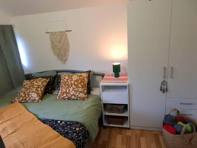 a small bedroom with a bed and a night stand at Boho House 5 camp Terme Catez with promotional tickets prices in Čatež ob Savi