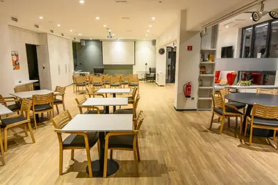 a classroom with tables and chairs and a chalkboard at Accommodation Vitalis in Ljubljana