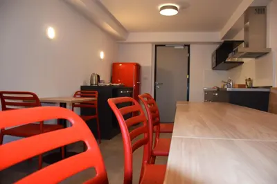 a room with a table and chairs and a kitchen at Accommodation Vitalis in Ljubljana