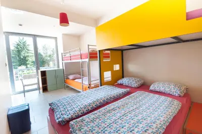 a bedroom with a bed and bunk beds at Simbol Rooms with free private parking in Ljubljana
