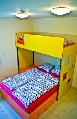 a bedroom with a bunk bed with a yellow at Simbol Rooms with free private parking in Ljubljana