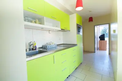 a kitchen with lime green cabinets and a sink at Simbol Rooms with free private parking in Ljubljana