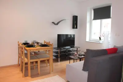a living room with a table and a dining room at Apartment Na skali in Kranj