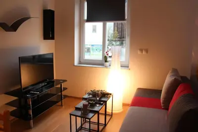 a living room with a couch and a television at Apartment Na skali in Kranj