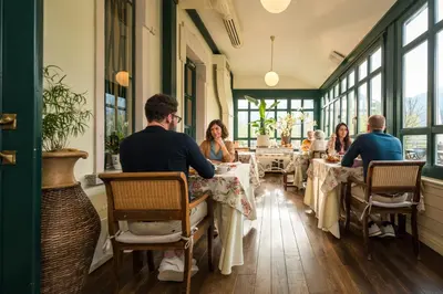 a group of people sitting at tables in a restaurant at Boutique Hotel Dobra Vila Bovec in Bovec