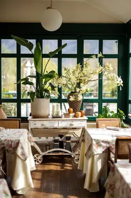 a dining room with a table with a plant on it at Boutique Hotel Dobra Vila Bovec in Bovec