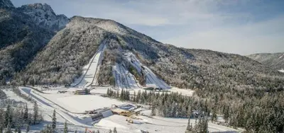 a snow covered mountain with a road on it at Apartma Anka *** in Kranjska Gora