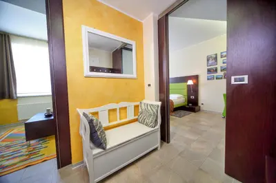 a small room with a bed and a mirror at Apartma Anka *** in Kranjska Gora