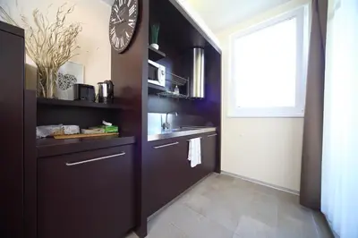 a kitchen with a large clock on the wall at Apartma Anka *** in Kranjska Gora