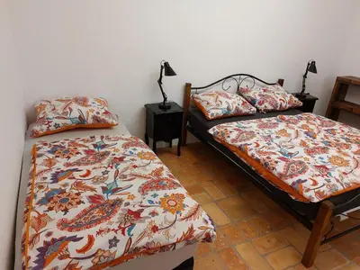 a bedroom with two beds and a lamp at Villa Coola in Ljubljana