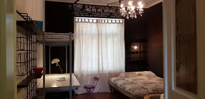a bedroom with a bed and a chandelier at Villa Coola in Ljubljana