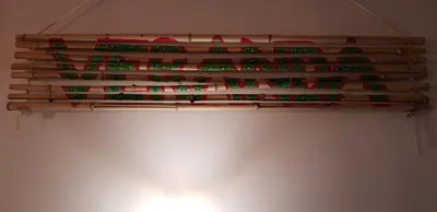 a bunch of wooden sticks hanging on a wall at Villa Coola in Ljubljana