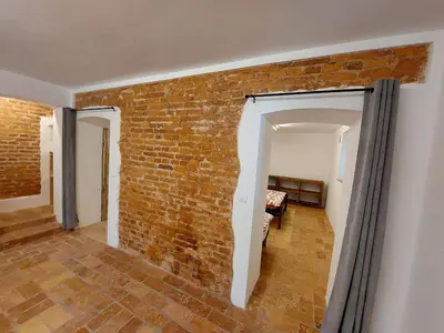 a room with a brick wall and an open doorway at Villa Coola in Ljubljana
