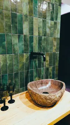 a bathroom with a stone sink with a water fountain at TEMPFER 2 Apartments & Rooms with new WELLNESS in Kranjska Gora