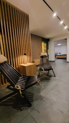 a bench in a room with a wooden wall at TEMPFER 2 Apartments & Rooms with new WELLNESS in Kranjska Gora