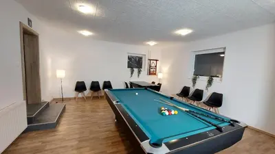 a living room with a pool table in it at TEMPFER 2 Apartments & Rooms with new WELLNESS in Kranjska Gora