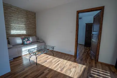 a living room with a couch and a glass table at TEMPFER 2 Apartments & Rooms with new WELLNESS in Kranjska Gora