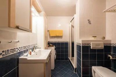 a bathroom with a sink and a toilet at Apartments Moravske Toplice in Moravske Toplice