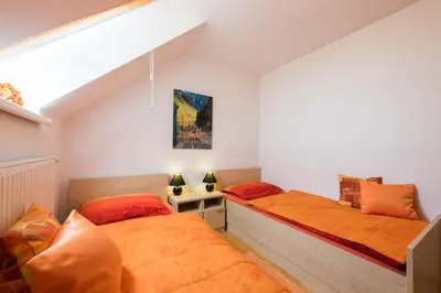two beds in a small room with a bed istg at Apartments Moravske Toplice in Moravske Toplice