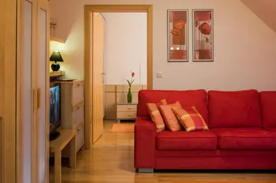 a red couch in a living room with a television at Apartments Moravske Toplice in Moravske Toplice