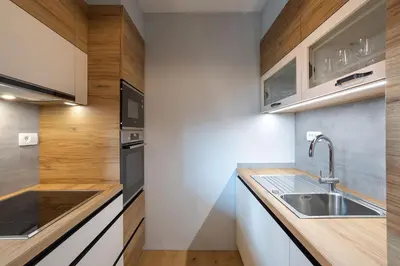 a kitchen with white cabinets and a sink at Apartments Tourist farm Matijovc in Naklo
