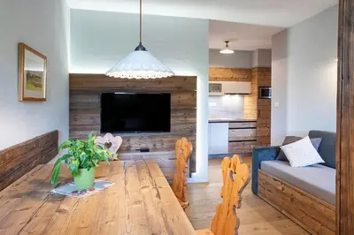 a living room with a wooden table and a couch at Apartments Tourist farm Matijovc in Naklo