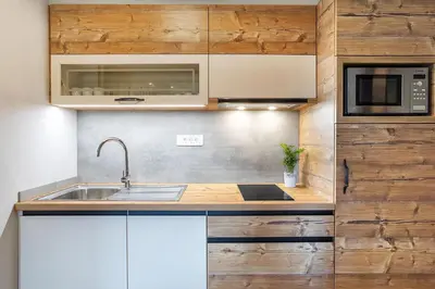 a kitchen with a sink and a microwave at Apartments Tourist farm Matijovc in Naklo