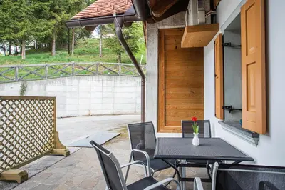 a black table and chairs on a patio at Apartments Tourist farm Matijovc in Naklo