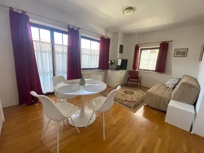a living room with a table and chairs and a couch at Resort Vidmar - Apartments Vidmar near Bled in Lesce