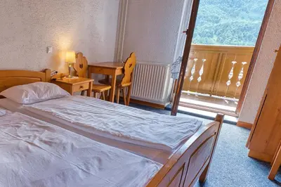 a bedroom with a bed and a table and a window at Pr Bevc in Bled