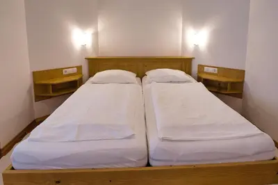 two beds sitting next to each other in a room at Pr Bevc in Bled