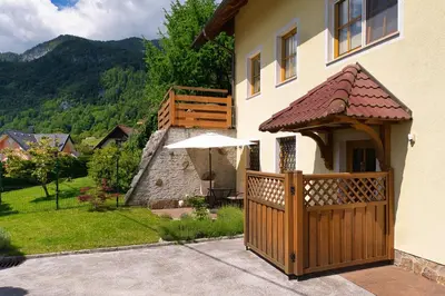 a house with a wooden gate and an umbrella at Pr Bevc in Bled