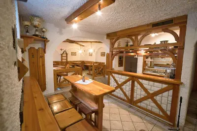 a restaurant with a wooden table and benches in a room at Pr Bevc in Bled
