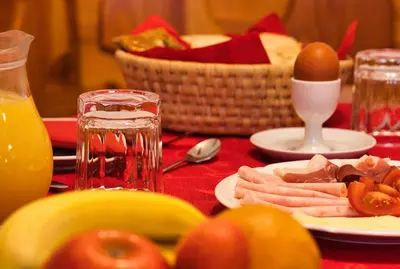 a table with a plate of food with tomatoes and eggs at Pr Bevc in Bled