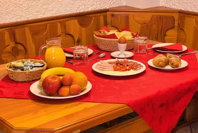 a table with plates of food on a red table cloth at Pr Bevc in Bled