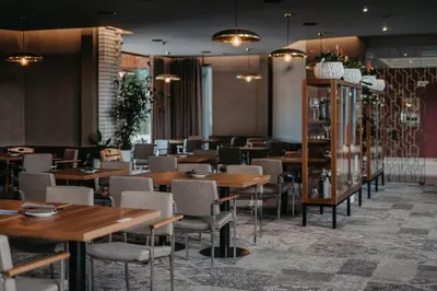 a dining room with wooden tables and chairs at Hotel Terme - Terme Čatež in Čatež ob Savi