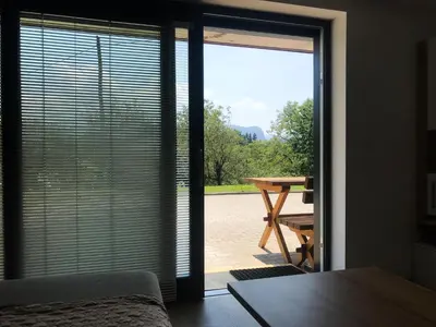 a sliding glass door with a view of a patio at Apartment Tosca near Vintgar and Lake Bled in Zgornje Gorje