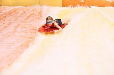 a woman on a raft in the water on a roller coaster at Apartments Čatež - Terme Čatež in Čatež ob Savi