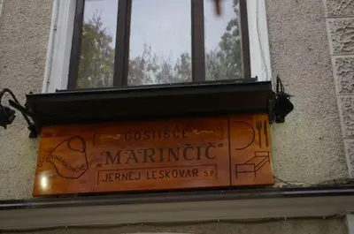 a window with a sign on the side of a building at Marinčič Inn in Škocjan