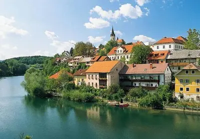 a town on a hill next to a river at Marinčič Inn in Škocjan
