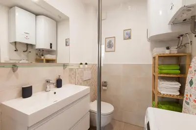 a bathroom with a white sink and a toilet at Felix apartment Tour As Ljubljana in Ljubljana