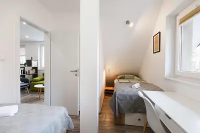 a small bedroom with two beds and a window at Felix apartment Tour As Ljubljana in Ljubljana