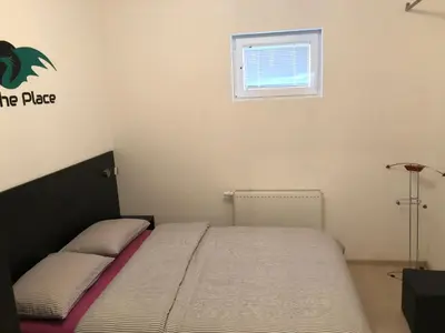 a bedroom with a bed and a window at The Place in Ljubljana